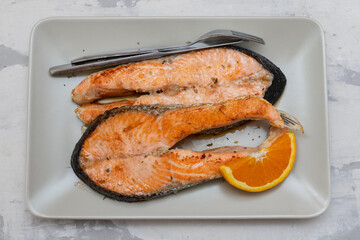 fried salmon on dish on ceramic background