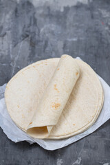 tortilla on white paper on ceramic background