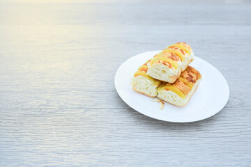Loaves of cheese bread in a plate on wooden table 