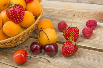 Various summer Fresh berries in a bowl on rustic wooden table. .Antioxidants, detox diet, organic fruits.