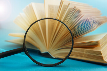 Stack book with magnifying glass
