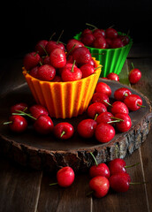 Fototapeta na wymiar red cherries on yellow and green bowl top view