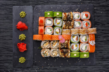 Japanese sushi food. Maki ands rolls with tuna, salmon, shrimp, crab and avocado. Top view of assorted sushi.