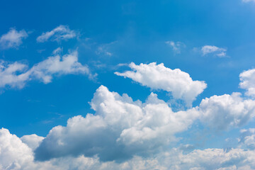 White clouds on blue sky background.