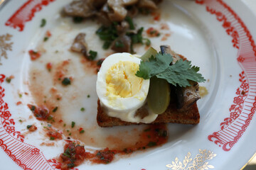 Crouton with egg and sprats