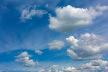 White clouds on blue sky background.