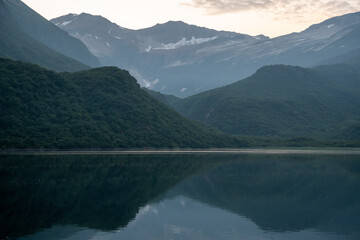 View of Geographic Harbor, Alaska at dusk with reflected mountains on a clear summer evening