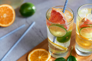 Homemade citrus water with grapefruit, orange, lemon and lime and ice in glass