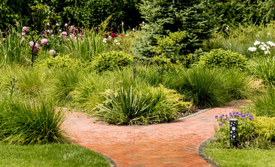 Obraz premium Beautiful garden landscape design. Summer background. Green grass background