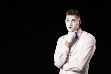 Man mime show emotion on isolated black background 
