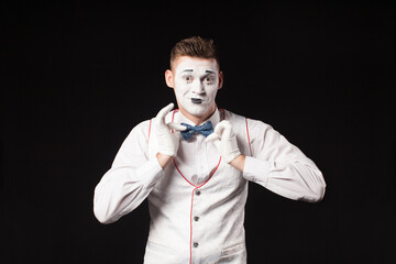 Man mime show emotion on isolated black background 