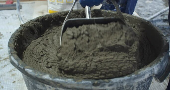Close up of the filling up process of the plaster hopper bucket, 4k