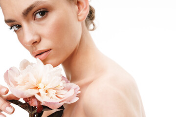 Fototapeta premium Image of beautiful caucasian young shirtless woman holding peony flower