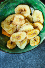 banana chips sweet and healthy snack Menu concept serving size. food background top view copy space for text