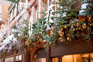 Golden christmas decorations with christmas trees on building in center of Strasbourg, France during xmas time. Capital of Christmas in Europe - atmosphere of holidays. Market in Europe