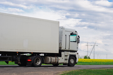 Truck with container on highway, cargo transportation concept. Shaving effect.