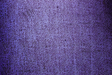 Purple colored abstract wall background with textures of different shades of purple or violet