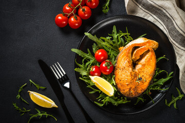 Salmon fish with fresh salad.