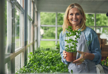 Beautiful botanist demonstrating the curly parsley seedlings