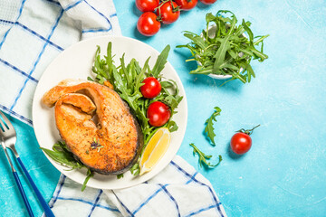 Salmon fish with fresh salad.