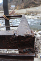 metal rod having flowing river in the background