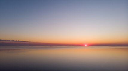 Obraz premium Drone of mist rising off of Ontario lake at sunrise