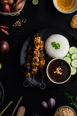 Chicken satay skewers with rice and peanut dipping sauce