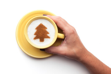 Top view of a cup of coffee with cream decorated. Food art creative concept image, drawing with cinnamon powder over white background.