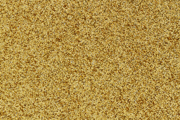 Gold glitter textured paper closeup background