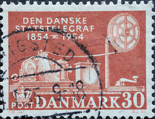 DENMARK - CIRCA 1954: A postage stamp from Denmark showing a telegraph machine from 1854