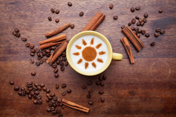 Top view of a cup of coffee with cream decorated. Food art creative concept image, drawing with cinnamon powder over wooden background.