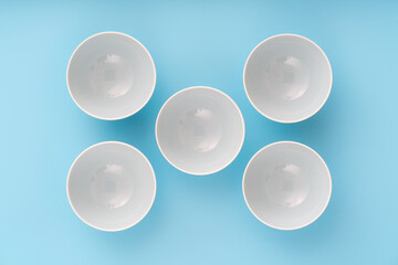 dinnerware, plates bowls on lilac table, top view,  flat lay.