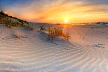 Beautiful summer sunset over beach at Baltic sea - obrazy, fototapety, plakaty