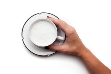 Fototapeta premium A rustic mug with coffee cream. Food art creative concept image, drawing with cinnamon powder over milk cream in a white background.