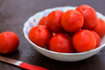 Red organic tomatoes in a bowl