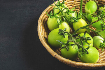 .Fresh green tomatoes in a basket
