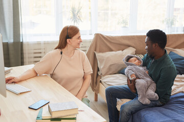 Side view portrait of modern mixed race family with mother working from home and African-American...