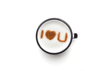 A rustic mug with coffee cream. Food art creative concept image, drawing with cinnamon powder over cream in a white background.
