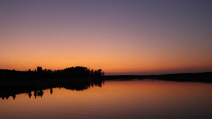 Fototapeta na wymiar Beautiful landscape of sunset reflected on a lake on summer