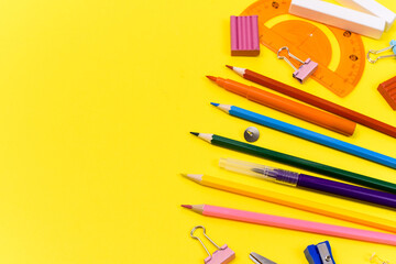 school supplies stationery on yellow background. View from above