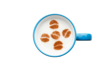 A rustic mug with coffee cream. Food art creative concept image, drawing with cinnamon powder over cream in a white background.
