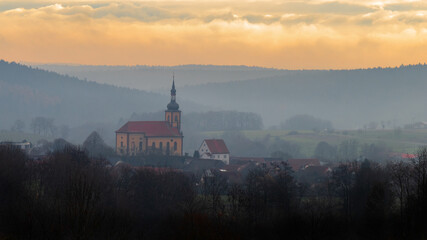 Fototapeta premium Small village in the foggy morning light
