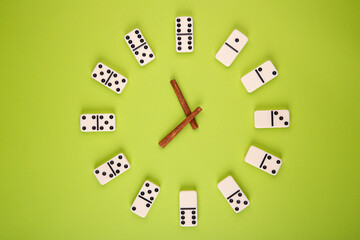White bones made as a watch with arrows on a green background