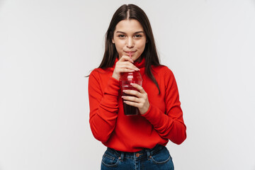 Photo of cheerful woman smiling and drinking soda from plastic glass