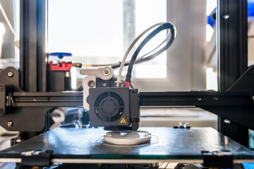 The 3D printer prints white plastic model