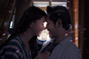 Asian couple in love hugging each other