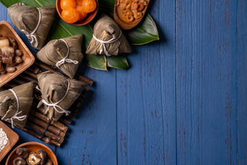 zongzi - Dragon Boat Festival concept Rice dumpling, traditional Chinese food on blue wooden background for Duanwu Festival, top view, flat lay design concept.