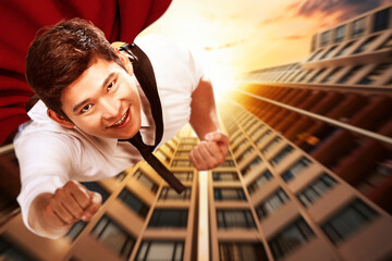 Asian businessman with a cloak flying like a superhero © Leo Lintang