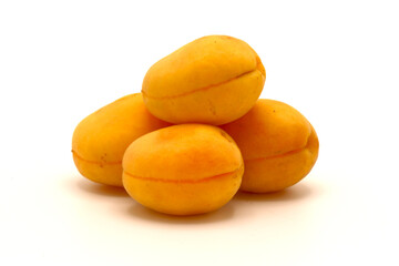 Four ripe apricot on a light background. Natural fruits. Close-up.