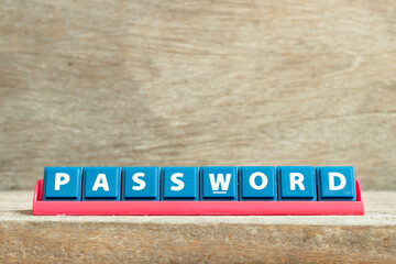 Tile letter on red rack in word password on wood background